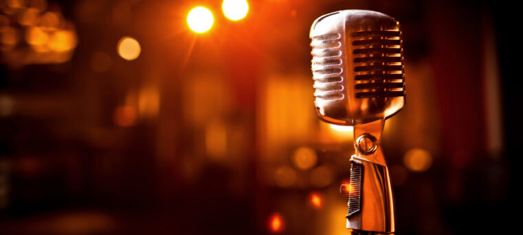 Retro microphone on stage in restaurant. Blurred background